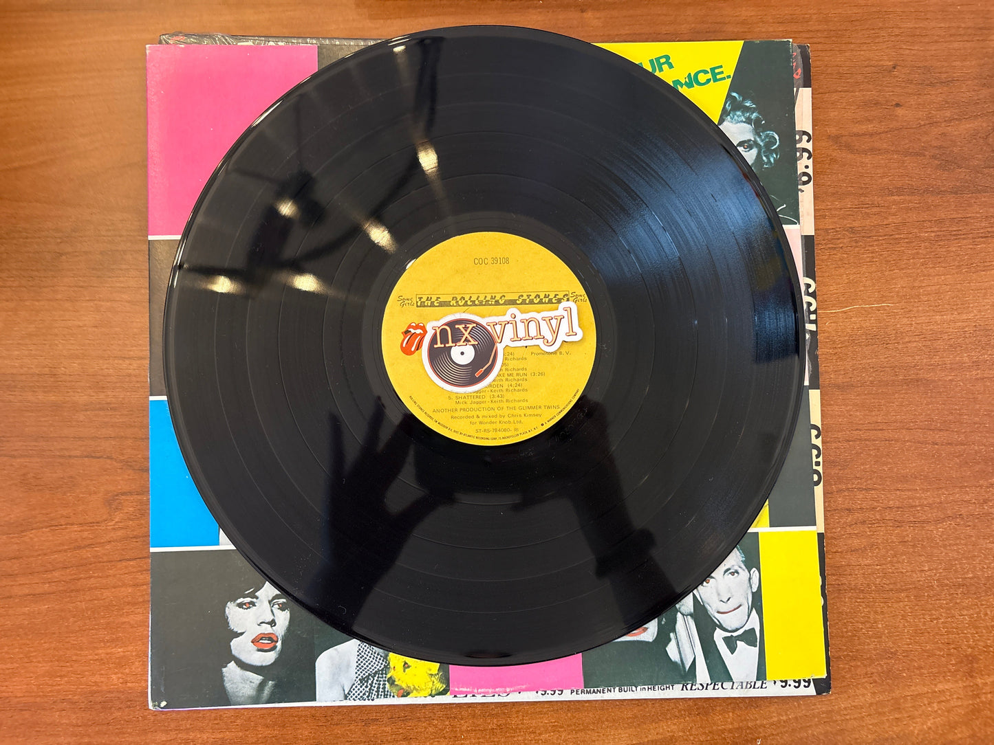 Vinyl record with a yellow label on a colorful album cover