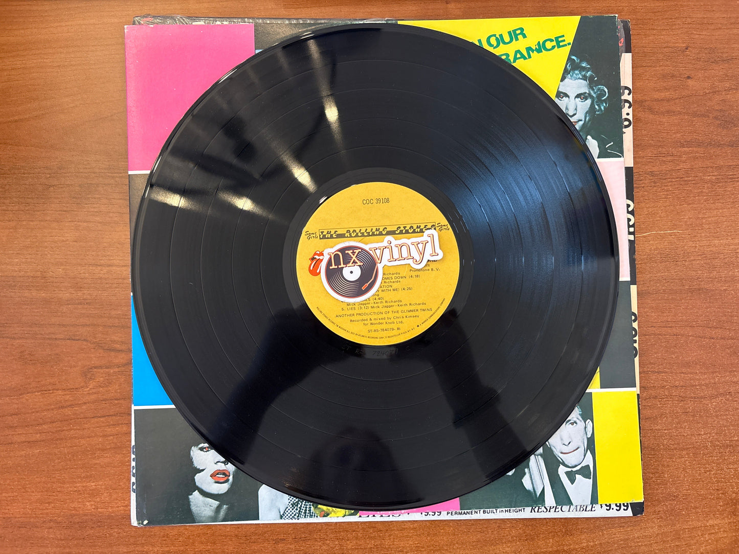 Vinyl record with a yellow label on a colorful album cover