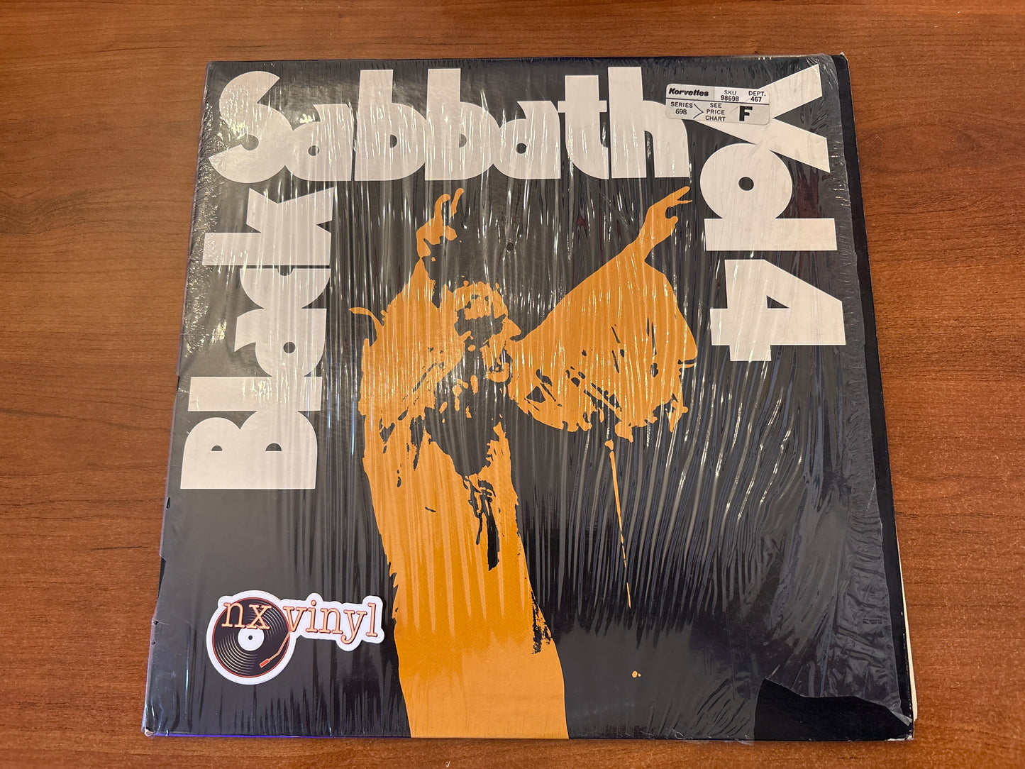 Vinyl record cover for Black Sabbath album on a wooden surface