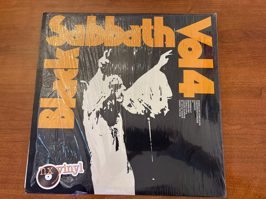 Vinyl record cover for Black Sabbath's 'Vox Vinyl' album on a wooden surface