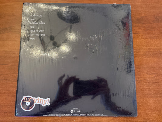 Vinyl record cover with 'n' vinyl logo on a wooden surface