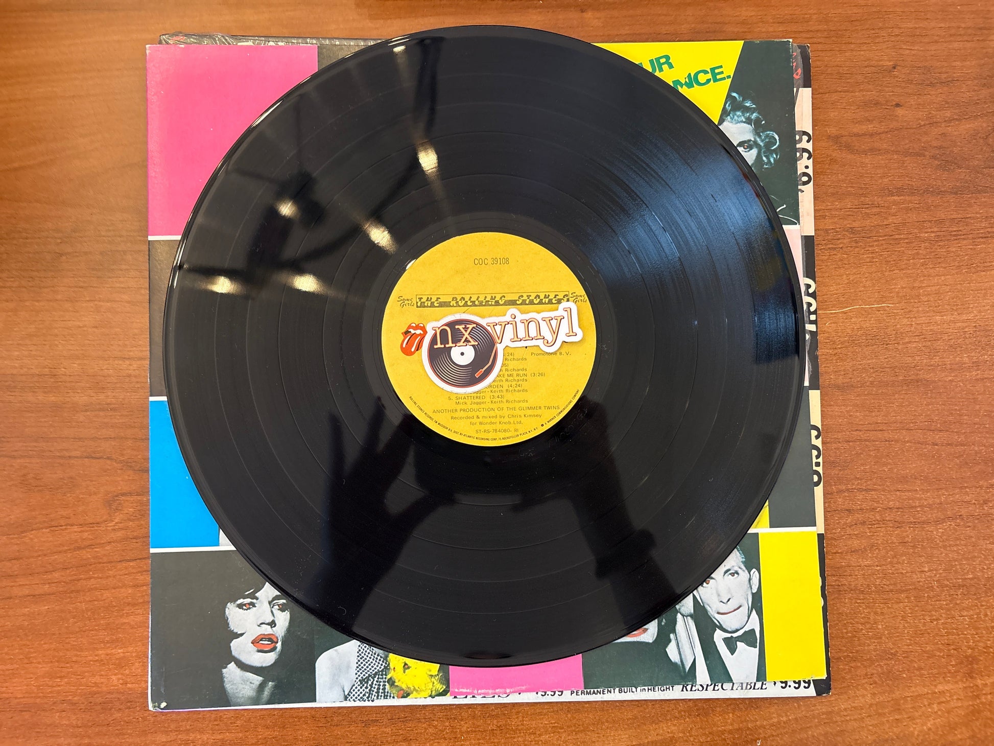 Vinyl record with a yellow label on a colorful album cover
