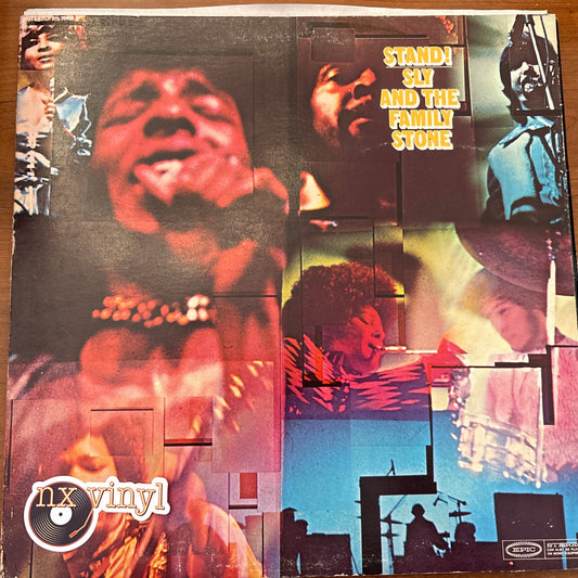 Vinyl record cover with multiple images of a person and text on a wooden surface