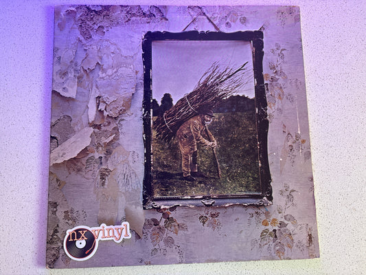 Vinyl record cover with distressed texture and central image of a person with a bundle of sticks.