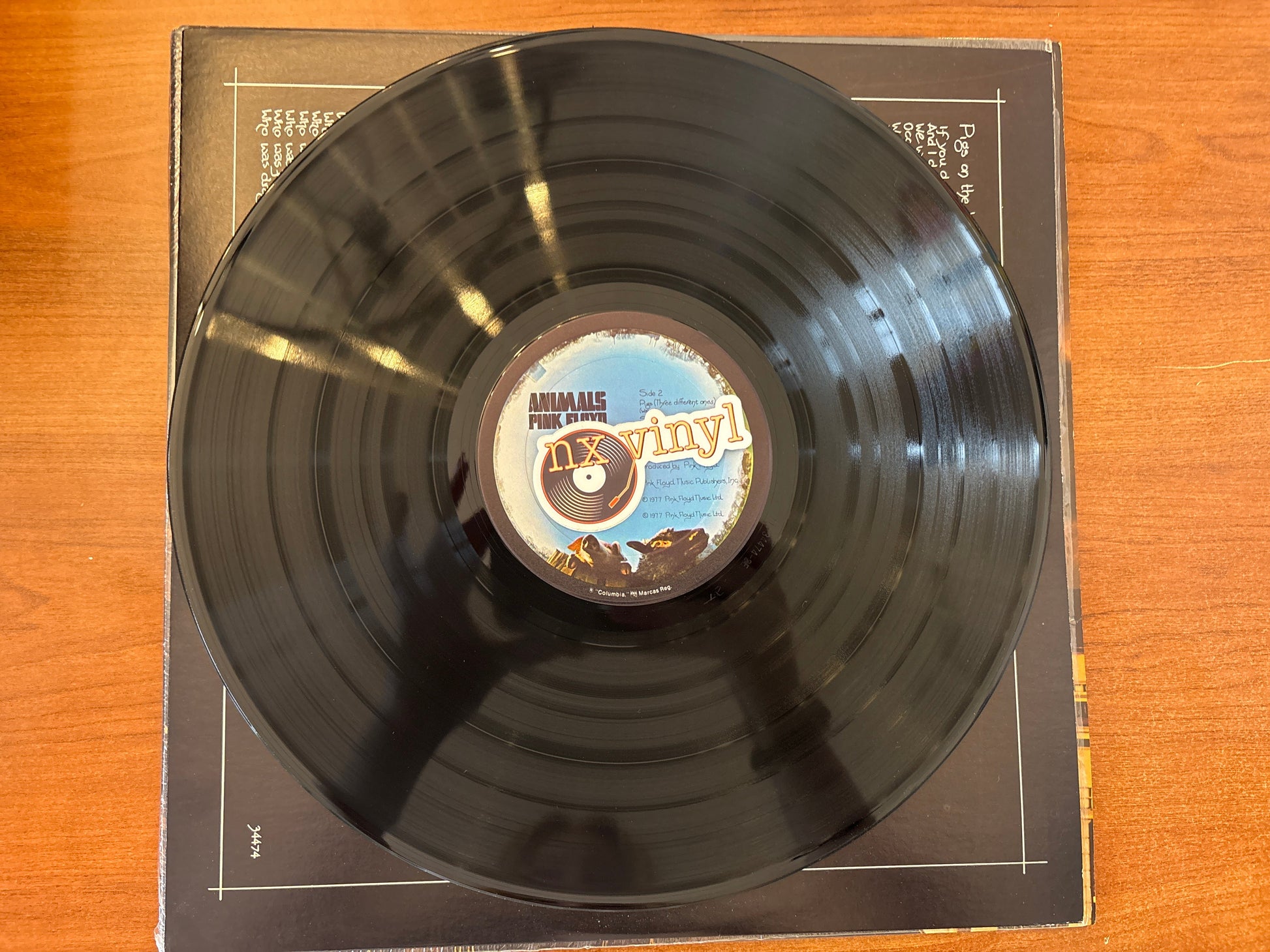 Vinyl record with a label on a wooden surface