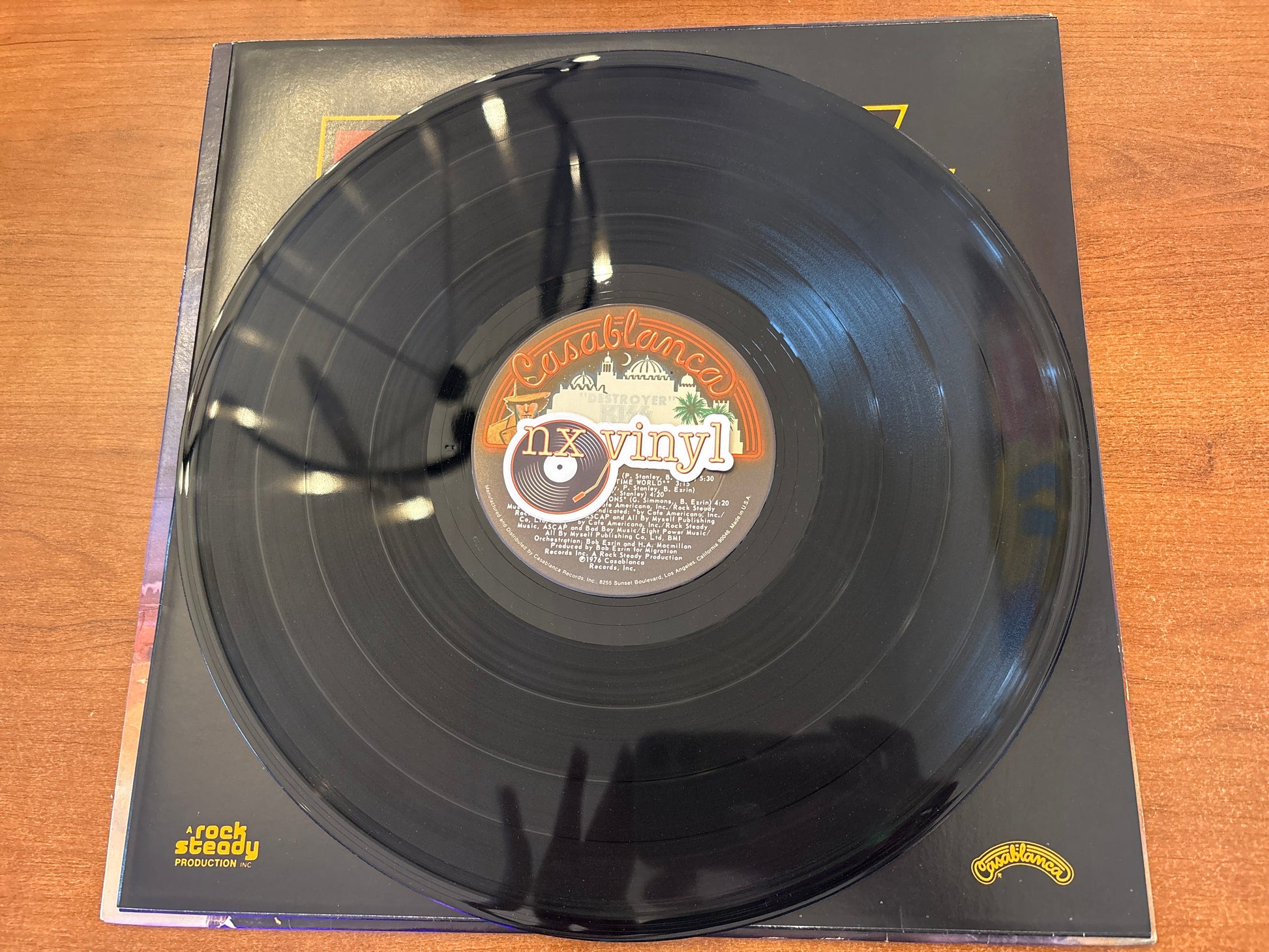 Vinyl record with a label on a wooden surface