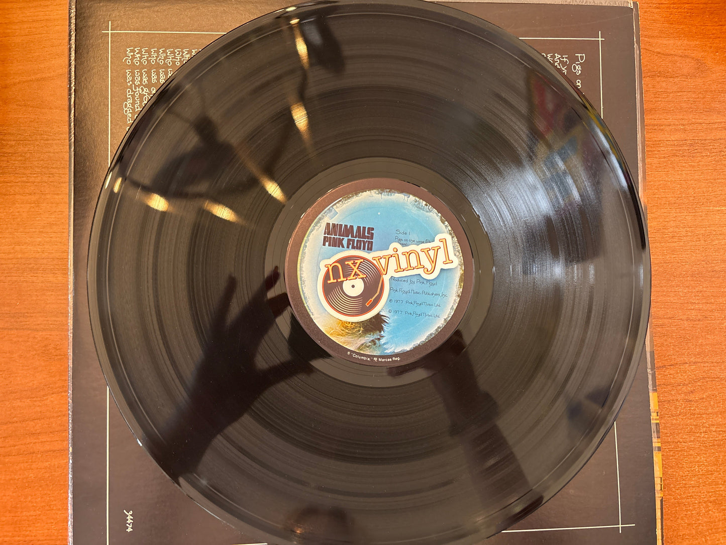 Vinyl record with a clear label on a wooden surface