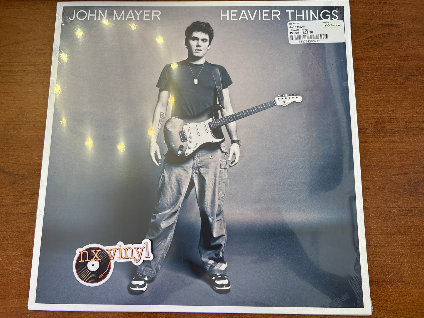 Album cover of 'Heavier Things' by John Mayer with a person holding a guitar.