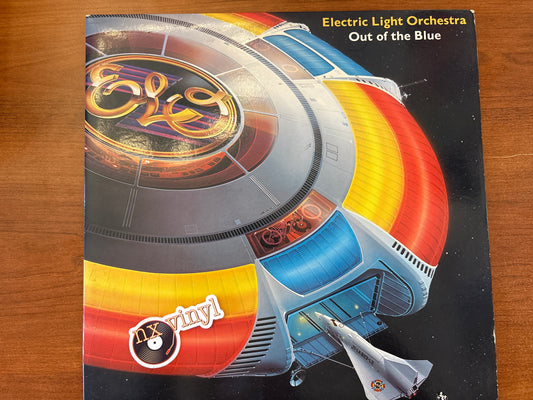Album cover of Electric Light Orchestra's 'Out of the Blue' on a wooden surface