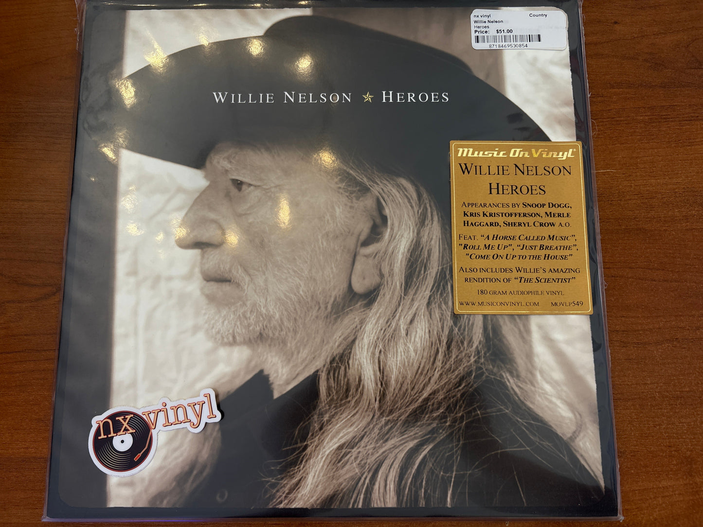 Vinyl record cover with Willie Nelson's face and album details on a wooden surface